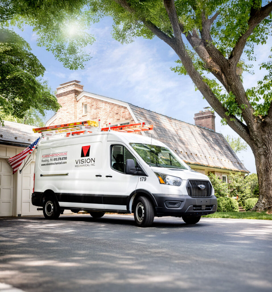 vision mechanical work van parked in front of beautiful residential home